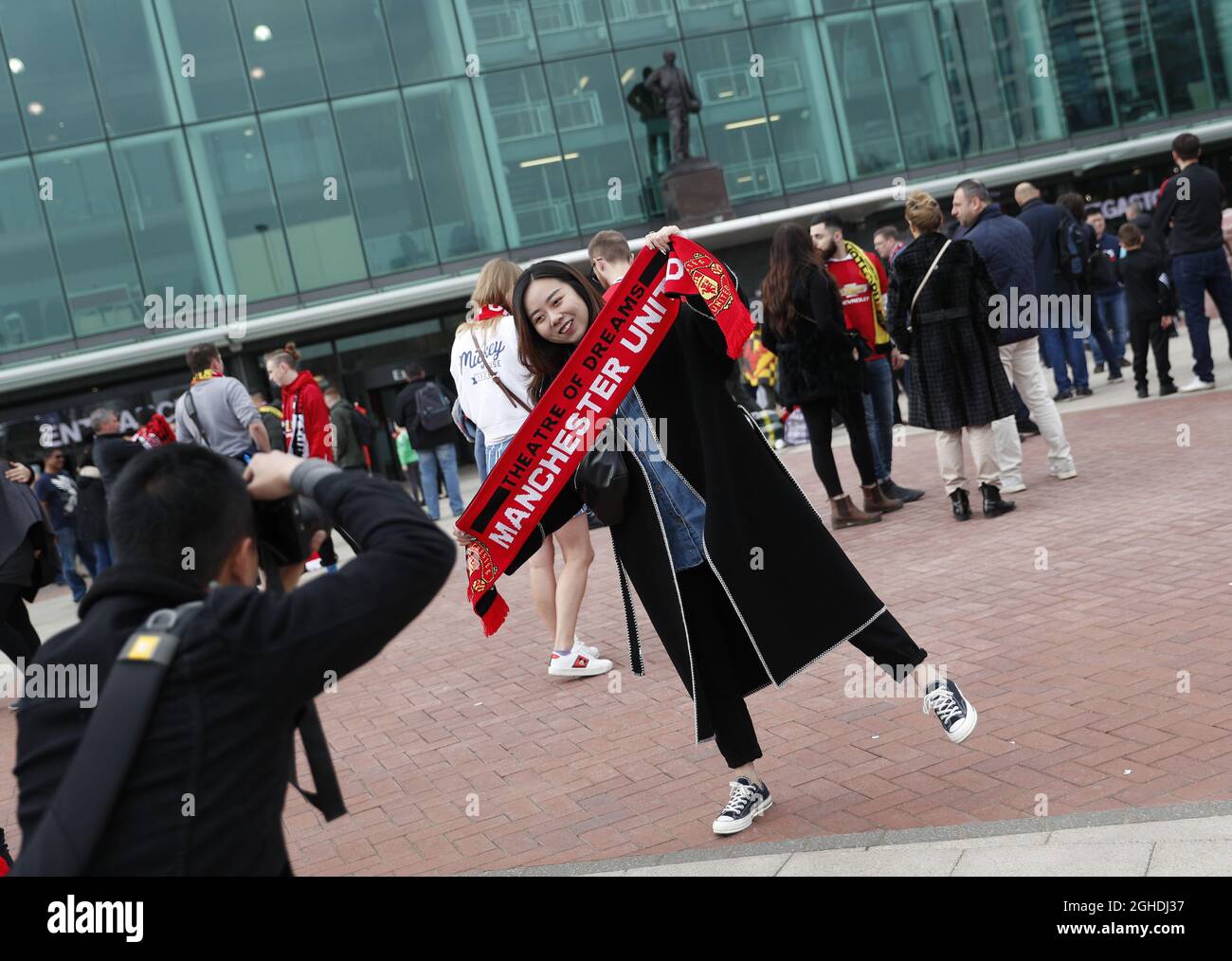 Fans pose for pictures outside the ground during the Premier League match at Old Trafford, Manchester. Picture date: 30th March 2019. Picture credit should read: Darren Staples/Sportimage via PA Images Stock Photo