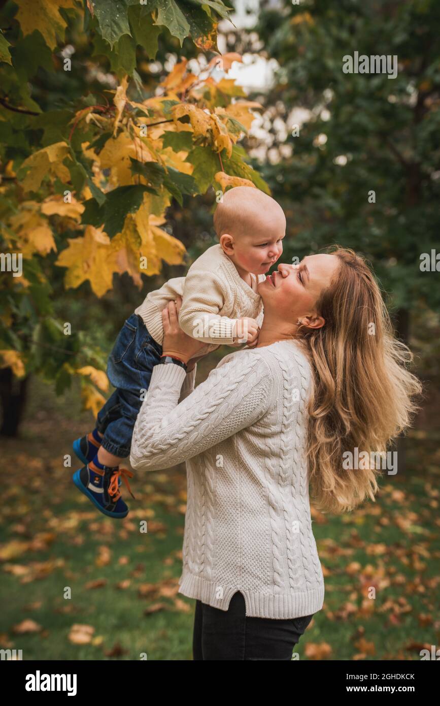 mother and her baby boy, enjoying the autumn day in park Stock Photo ...
