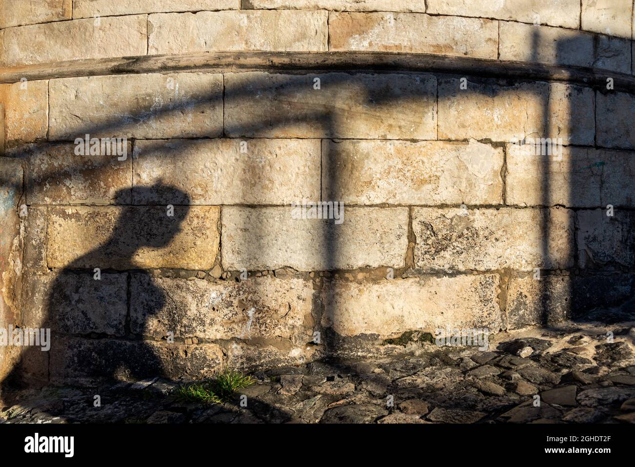 Salvador, Bahia, Brazil - July 18, 2021: Silhouette of the shadows of people on the stone wall in Pelourinho. Stock Photo