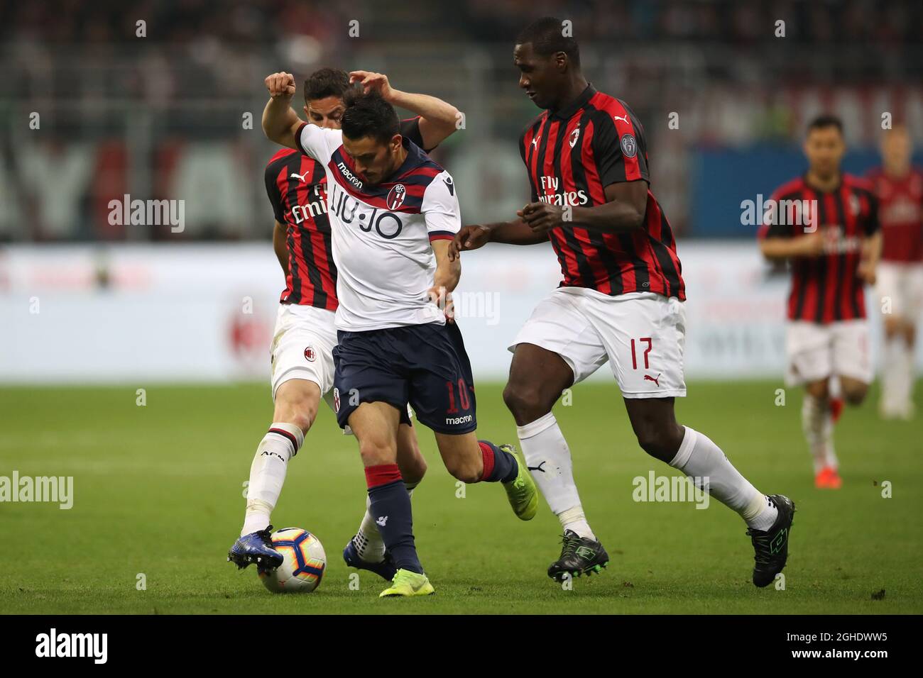 Nicola Sansone of Bologna is challenged by Mateo Musacchio and Cristian Zapata of AC Milan during the Serie A match at Giuseppe Meazza, Milan. Picture date: 6th May 2019. Picture credit should read: Jonathan Moscrop/Sportimage via PA Images Stock Photo