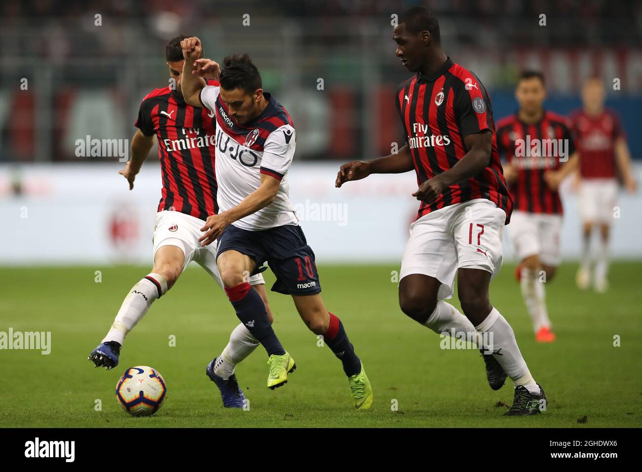 Nicola Sansone of Bologna is challenged by Mateo Musacchio of AC Milan as Cristian Zapata provides support during the Serie A match at Giuseppe Meazza, Milan. Picture date: 6th May 2019. Picture credit should read: Jonathan Moscrop/Sportimage via PA Images Stock Photo