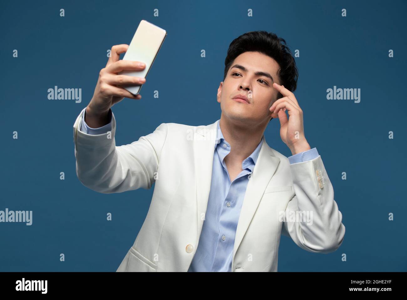Fashionable young man using smart phone Stock Photo