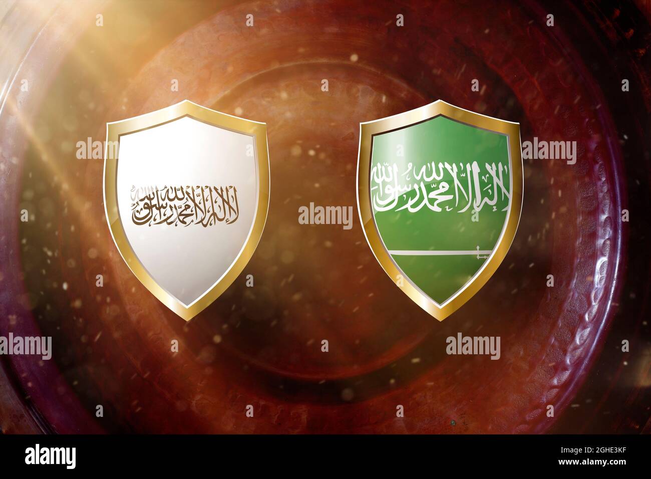 taliban and saudi arabia flag in golden shield on copper texture background. Stock Photo