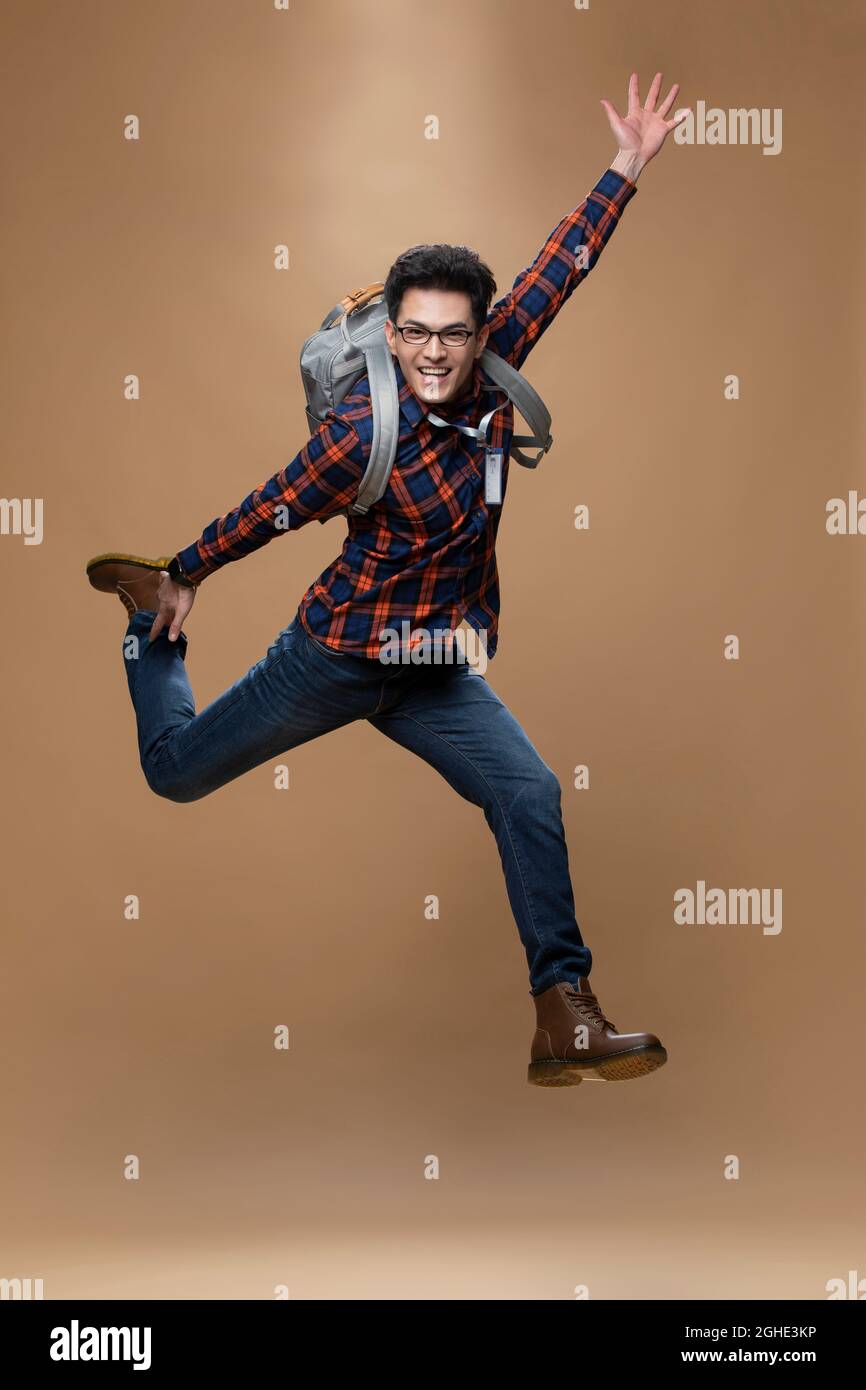 Cheerful young man jumping Stock Photo