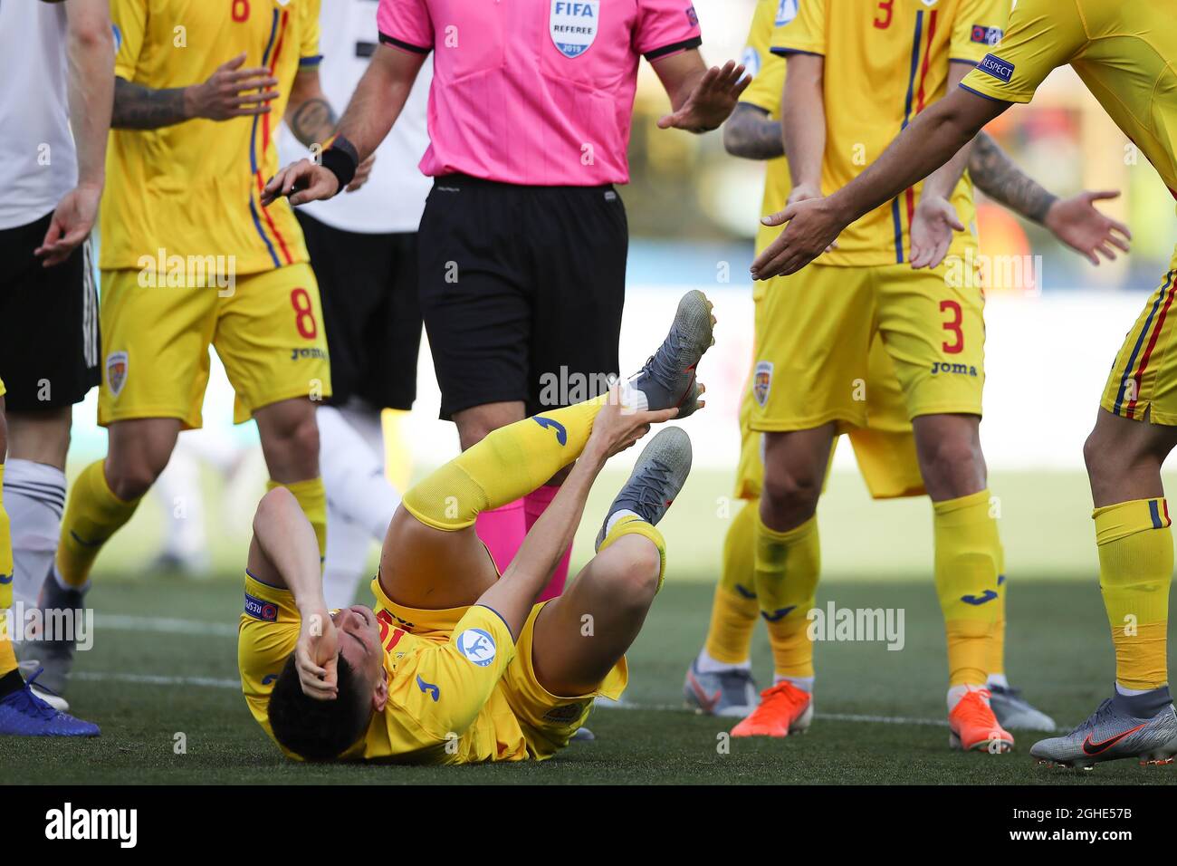 Ianis HagiÊof Romania rolls around in the penalty area after being fouled by Timo Baumgartl of Germany by stepping on his ankle to concede a penalty during the UEFA Under-21 Championship match at Renato Dall'Ara, Bologna. Picture date: 27th June 2019. Picture credit should read: Jonathan Moscrop/Sportimage via PA Images Stock Photo