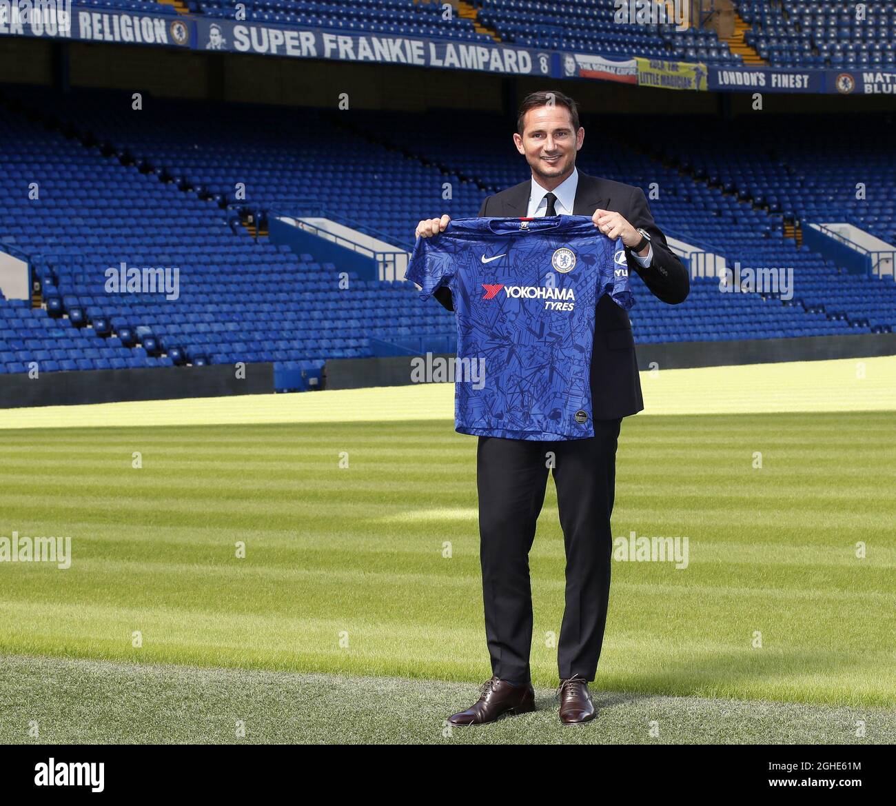 London, UK. 04th July, 2019. New Chelsea head coach Frank Lampard holds the  Chelsea shirt up inside Stamford Bridge. Frank Lampard is announced as the  new manager of Chelsea FC at a