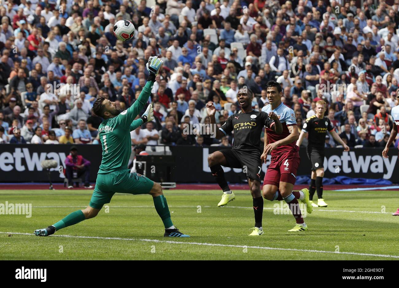 Raheem Sterling of Manchester City lobs the ball over Lukasz Fabianski of West Ham United for the third goal during the Premier League match at the London Stadium, London. Picture date: 10th August 2019. Picture credit should read: Darren Staples/Sportimage  via PA Images Stock Photo