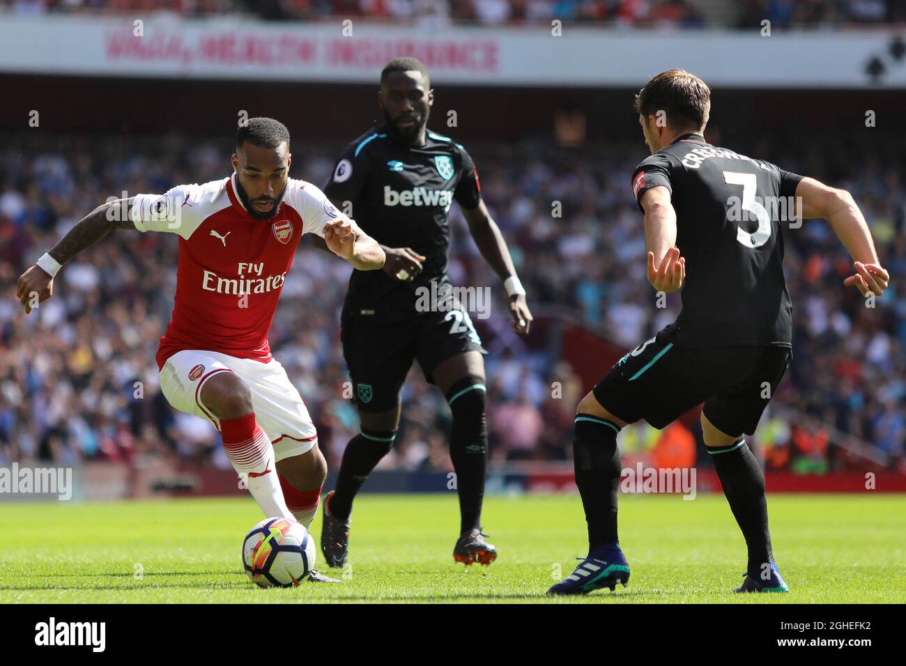 Alexandre Lacazette of Arsenal tries to find a way past Aaron Cresswell of West Ham United - Arsenal v West Ham United, Premier League, Emirates Stadium, London - 22nd April 2018. Stock Photo