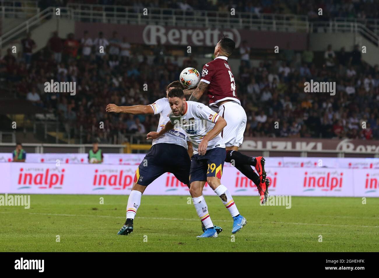 Andrea Rispoli and Panagiotis Tachtsidis of Lecce combine to foul Armando Izzo of Torino FC and concede a penalty during the Serie A match at Stadio Grande Torino, Turin. Picture date: 16th September 2019. Picture credit should read: Jonathan Moscrop/Sportimage via PA Images Stock Photo