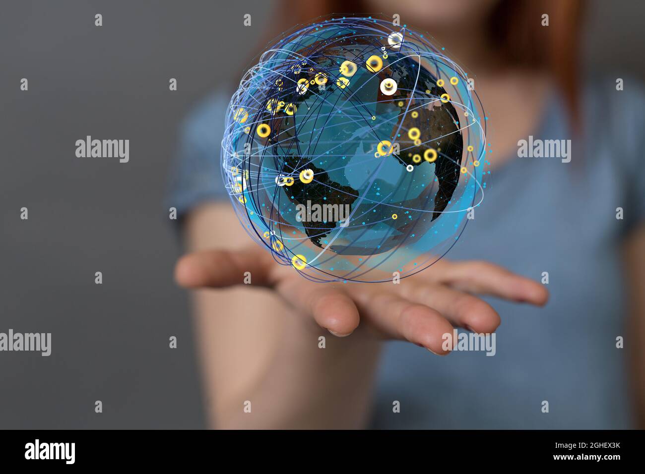 Selective focus of a 3D rendered globe hologram hovering over a female ...