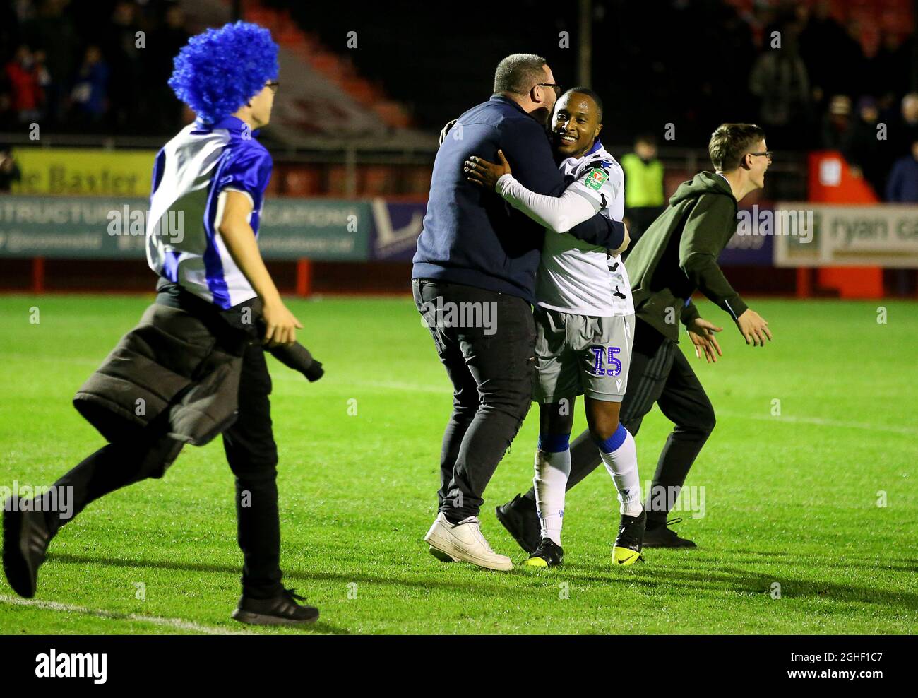 Colchester United's Callum Harriott celebrates with fans on the pitch after his side win the Carabao Cup match at Broadfield Stadium, Crawley. Picture date: 29th October 2019. Picture credit should read: Paul Terry/Sportimage via PA Images Stock Photo