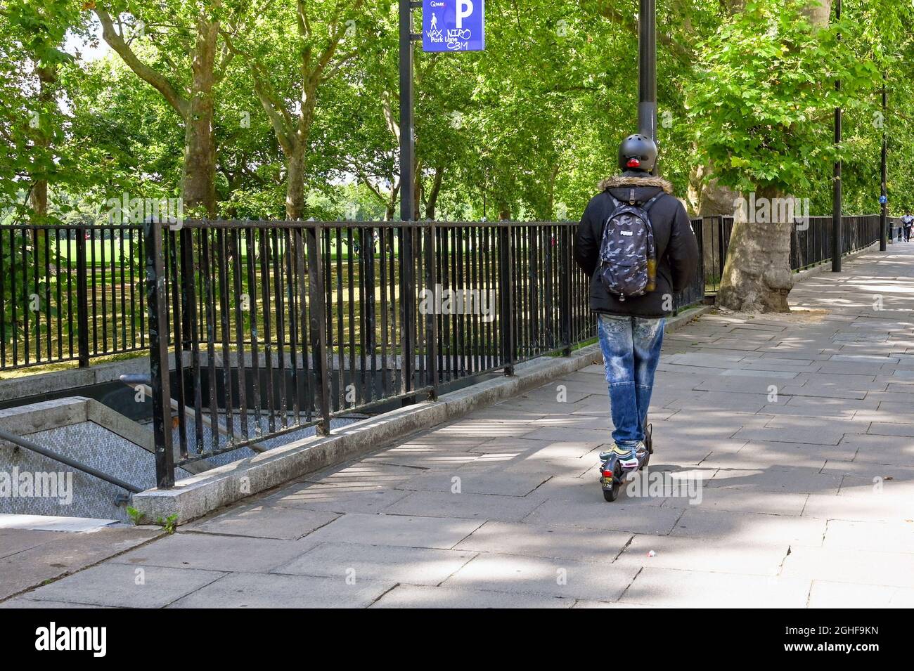 London, England August 2021 Person riding an electric scooter on a
