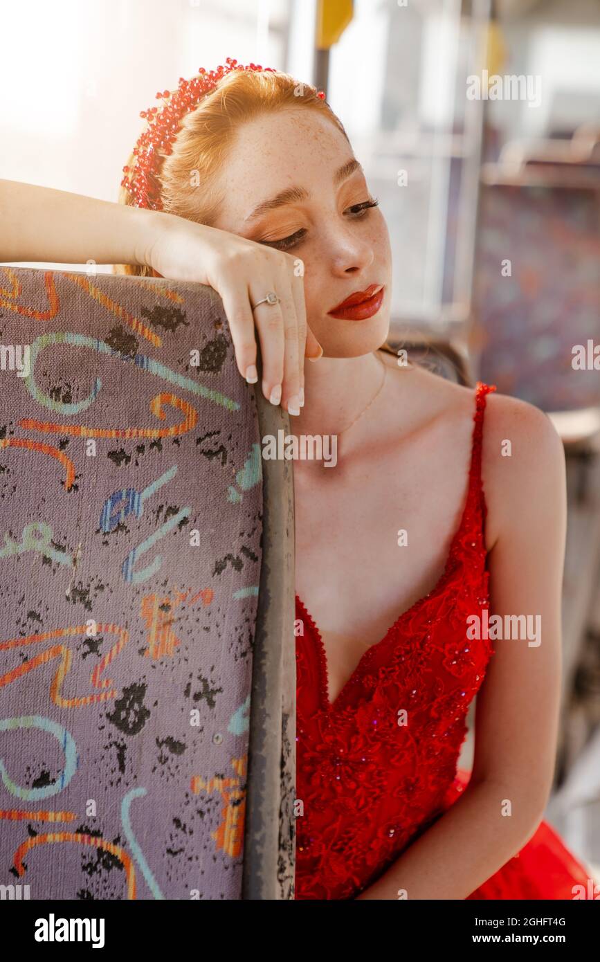 Alone and sad young beautiful woman is looking toughtful while she sit in a bus and traveling. . High quality photo Stock Photo