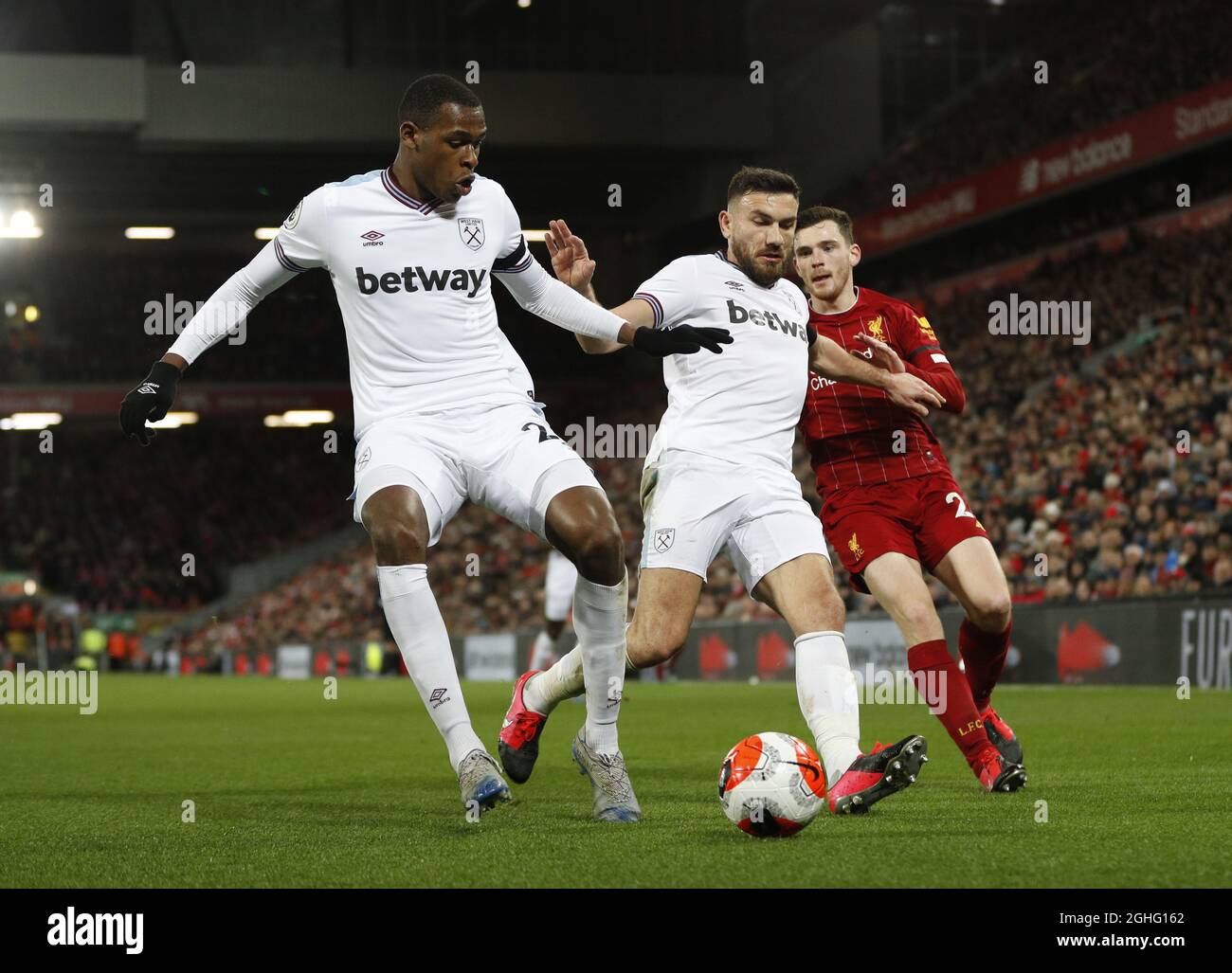 Issa Diop of West Ham United and Robert Snodgrass of West Ham United keep out Andrew Robertson of Liverpool  during the Premier League match at Anfield, Liverpool. Picture date: 24th February 2020. Picture credit should read: Darren Staples/Sportimage via PA Images Stock Photo