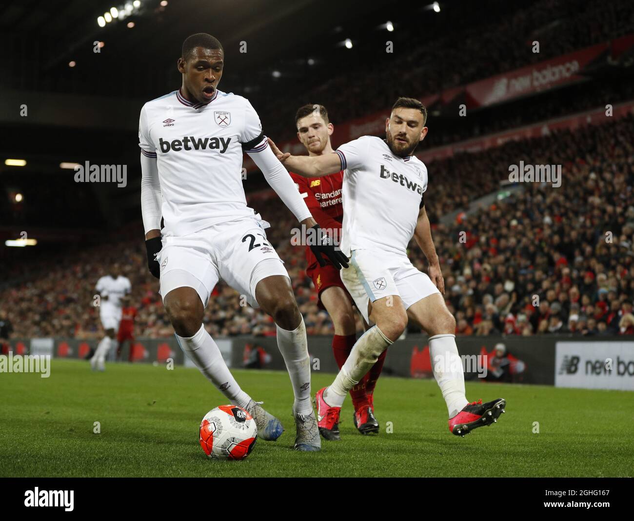 Issa Diop of West Ham United and Robert Snodgrass of West Ham United keep out Andrew Robertson of Liverpool  during the Premier League match at Anfield, Liverpool. Picture date: 24th February 2020. Picture credit should read: Darren Staples/Sportimage via PA Images Stock Photo