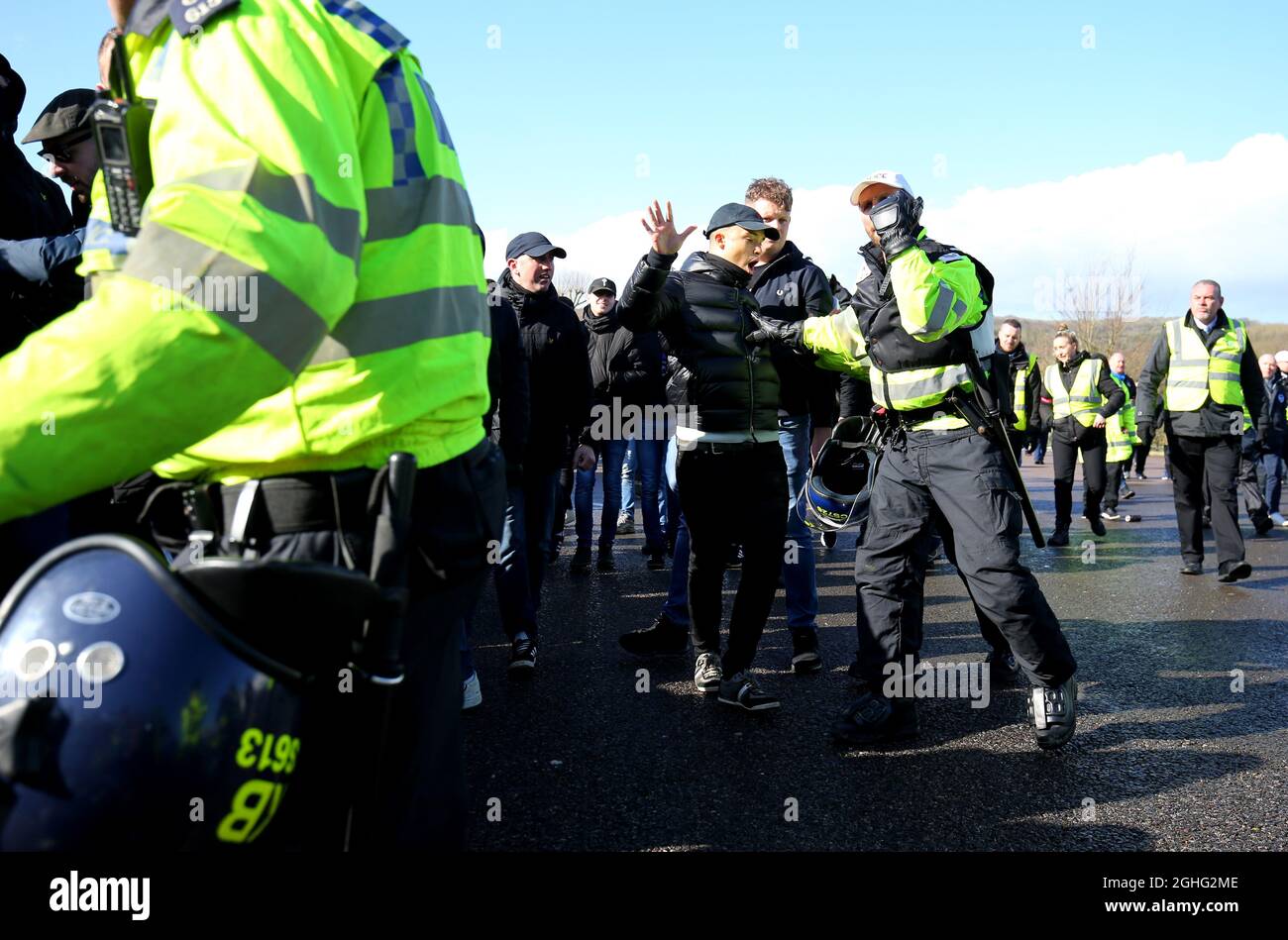 A police officer holds back Crystal Palace fan as they are escorted from the train station ahead of the Premier League match at the American Express Community Stadium, Brighton and Hove. Picture date: 29th February 2020. Picture credit should read: Paul Terry/Sportimage Stock Photo