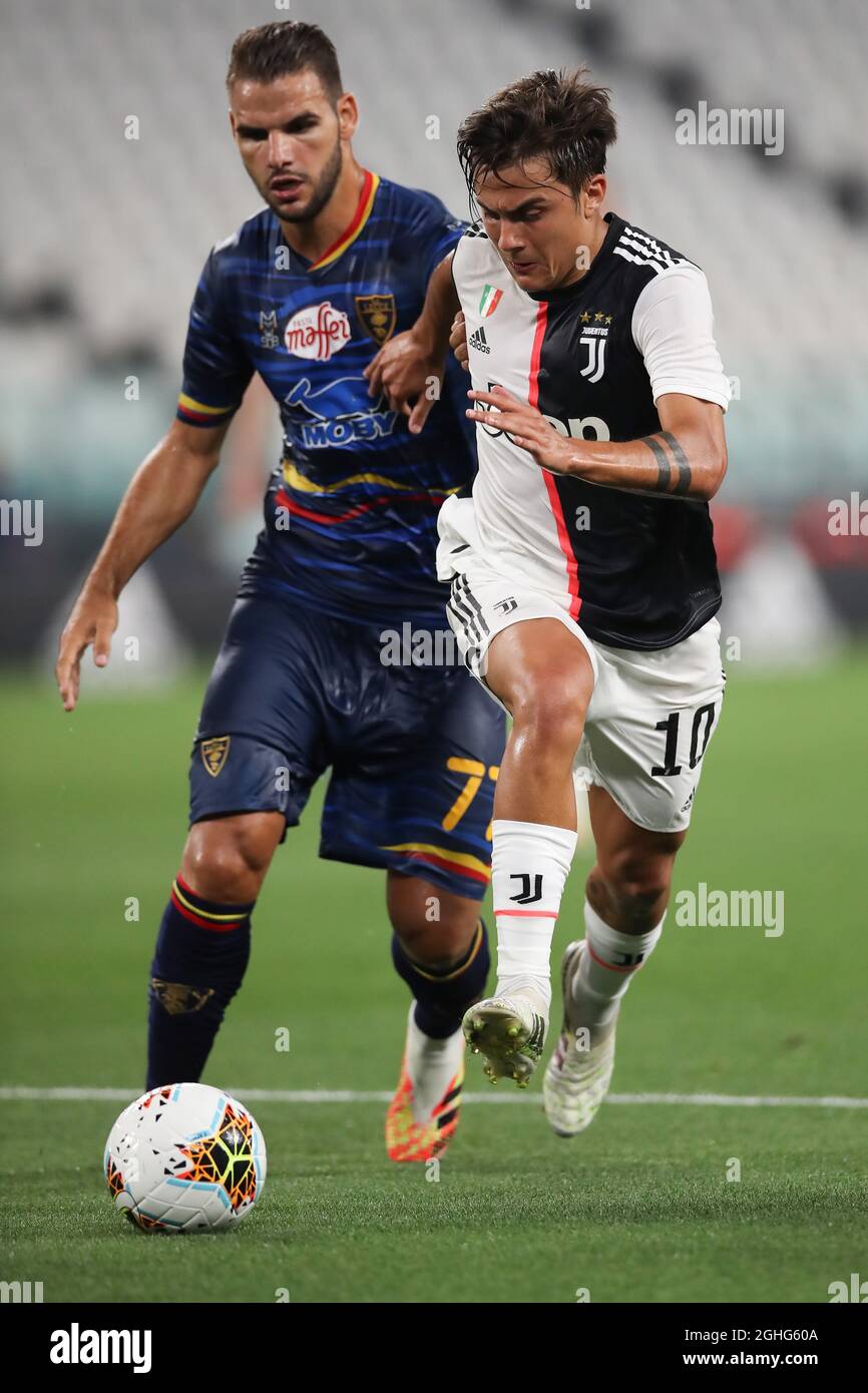 Juventus's Argentinian striker Paulo Dybala takes the ball past Lecce's Greek midfielder Panagiotis Tachtsidis during the Serie A match at Allianz Stadium, Turin. Picture date: 26th June 2020. Picture credit should read: Jonathan Moscrop/Sportimage via PA Images Stock Photo