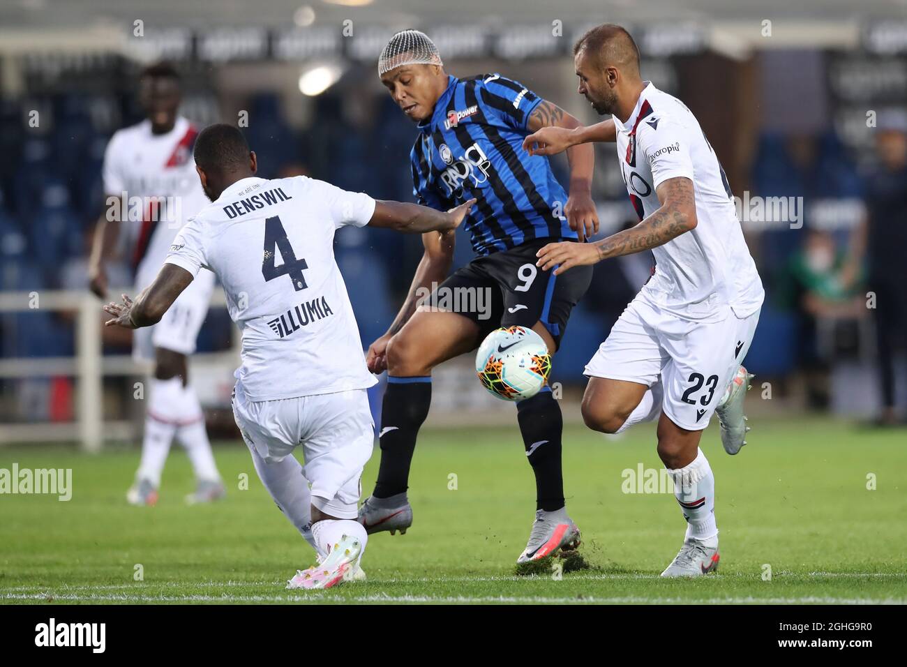 Dutch defender Stefano Denswil and Brazilian defender Larangeira Danilo of Bologna FC challenge Colombian striker Luis Muriel of Atalanta during the Serie A match at Gewiss Stadium, Bergamo. Picture date: 21st July 2020. Picture credit should read: Jonathan Moscrop/Sportimage via PA Images Stock Photo