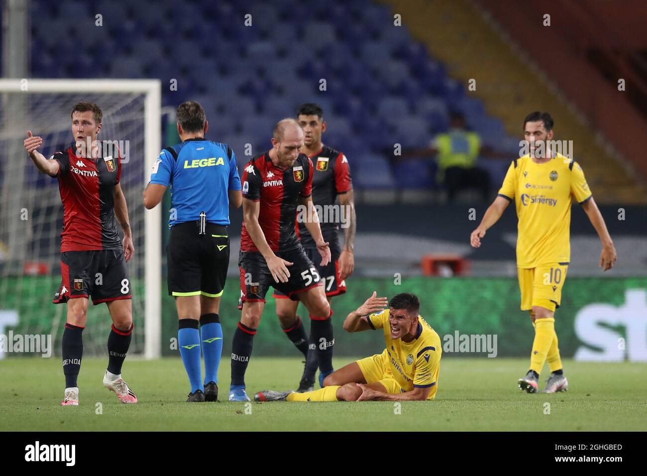 Matteo Pessina of Hellas Verona writhes in agony after dislocating his patella in a challenge with Cristian Romero of Genoa CFC whom was subsequently booked during the Serie A match at Luigi Ferraris, Genoa. Picture date: 2nd August 2020. Picture credit should read: Jonathan Moscrop/Sportimage via PA Images Stock Photo