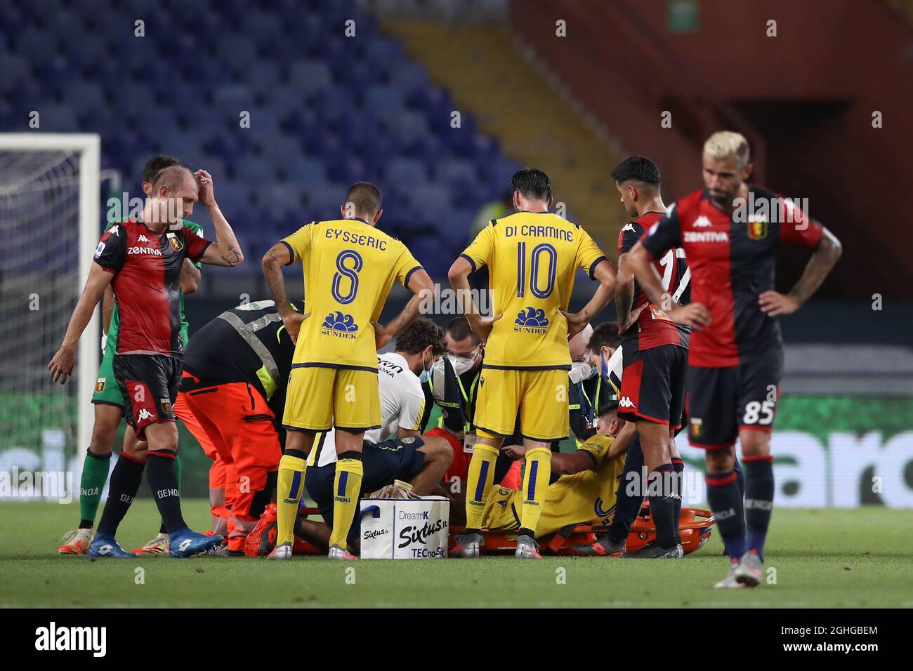 Matteo Pessina of Hellas Verona is placed onto a stretcher after dislocating his patella in a challenge with Cristian Romero of Genoa CFC whom was subsequently shown a yellow card by referee Massimiliano Irrati during the Serie A match at Luigi Ferraris, Genoa. Picture date: 2nd August 2020. Picture credit should read: Jonathan Moscrop/Sportimage via PA Images Stock Photo