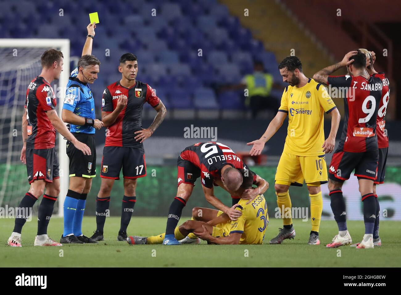 Matteo Pessina of Hellas Verona writhes in agony after dislocating his patella as Cristian Romero of Genoa CFC is shown a yellow card by referee Massimiliano Irrati for the challenge during the Serie A match at Luigi Ferraris, Genoa. Picture date: 2nd August 2020. Picture credit should read: Jonathan Moscrop/Sportimage via PA Images Stock Photo