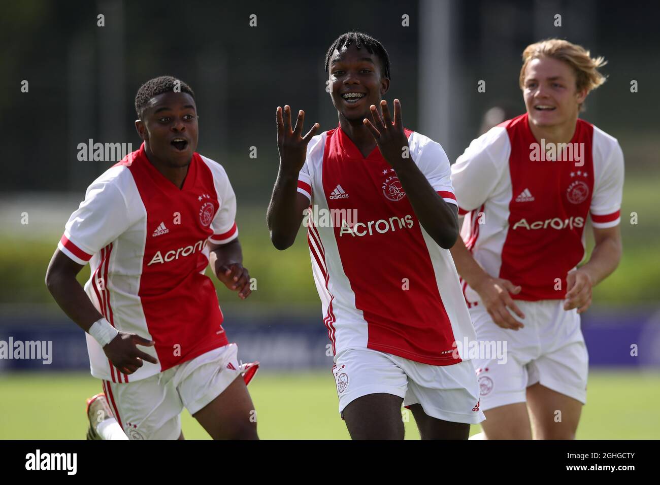 Joel Ideho of Ajax celebrates with team mates Sontje Hansen and Christian Rasmussen after scoring to give the side a 3-0 lead during the UEFA Youth League match at Colovray Sports Centre, Nyon. Picture date: 18th August 2020. Picture credit should read: Jonathan Moscrop/Sportimage via PA Images Stock Photo