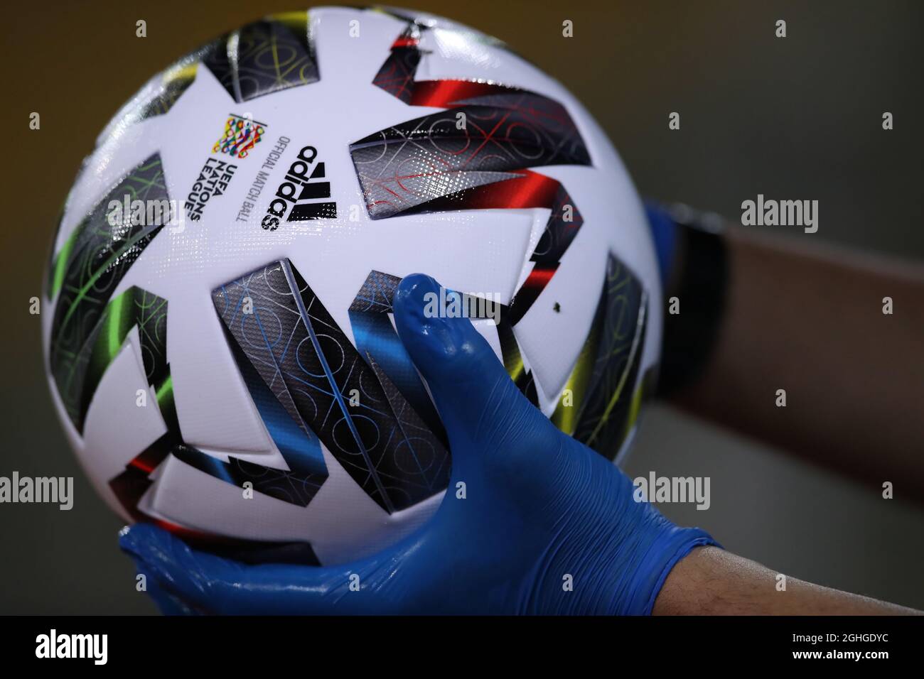 An official UEFA Nations League Adidas match ball is held by a member of  staff wearing protective plastic gloves during the UEFA Nations League  match at Stadio Ennio Tardini, Parma. Picture date:
