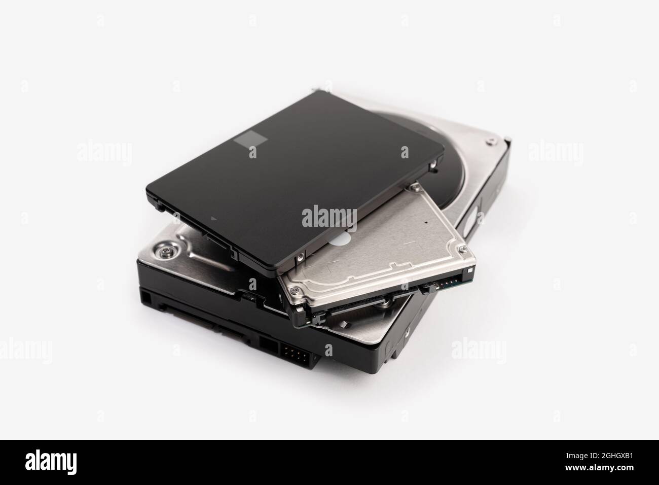 Pile of a variety of computer Hard disk drive HDD and SSD isolated on