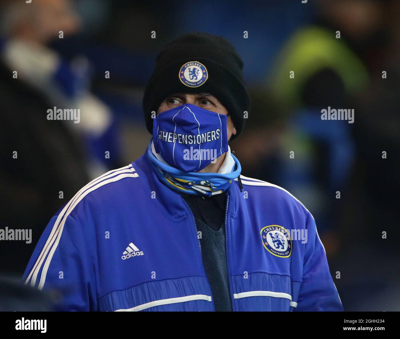 A Chelsea fan wearing a face mask during the Premier League match at  Stamford Bridge, London.