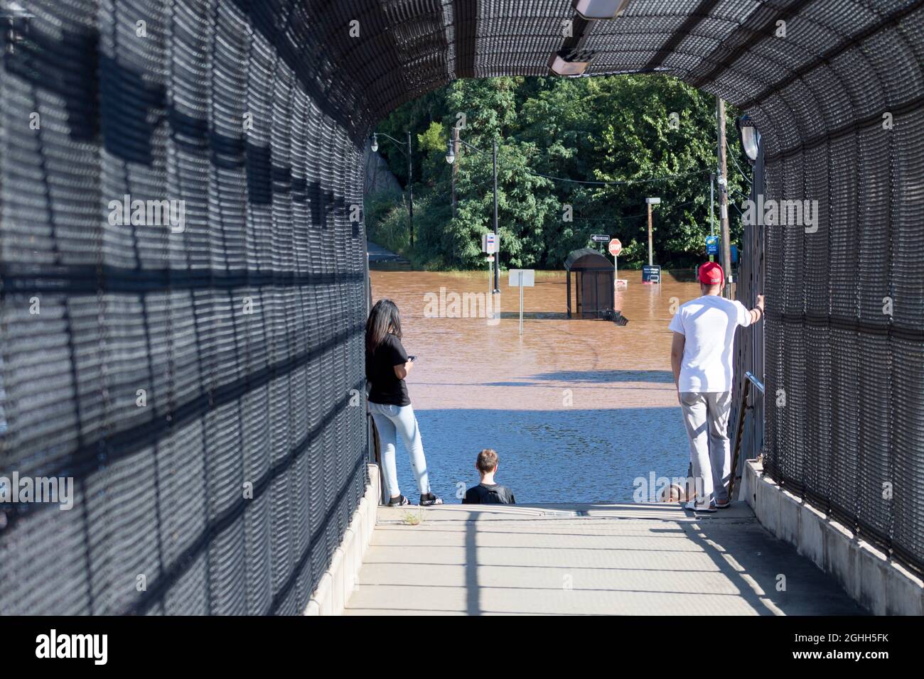 Locals view abandoned bus stop and flooded downtown streets in the devistating aftermath of Hurricane Ida. Stock Photo