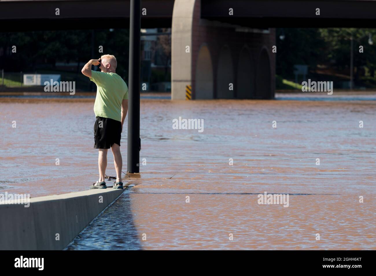 Local resident views the flooded downtown highway and streets in the aftermath of Tropical Storm Ida. Stock Photo
