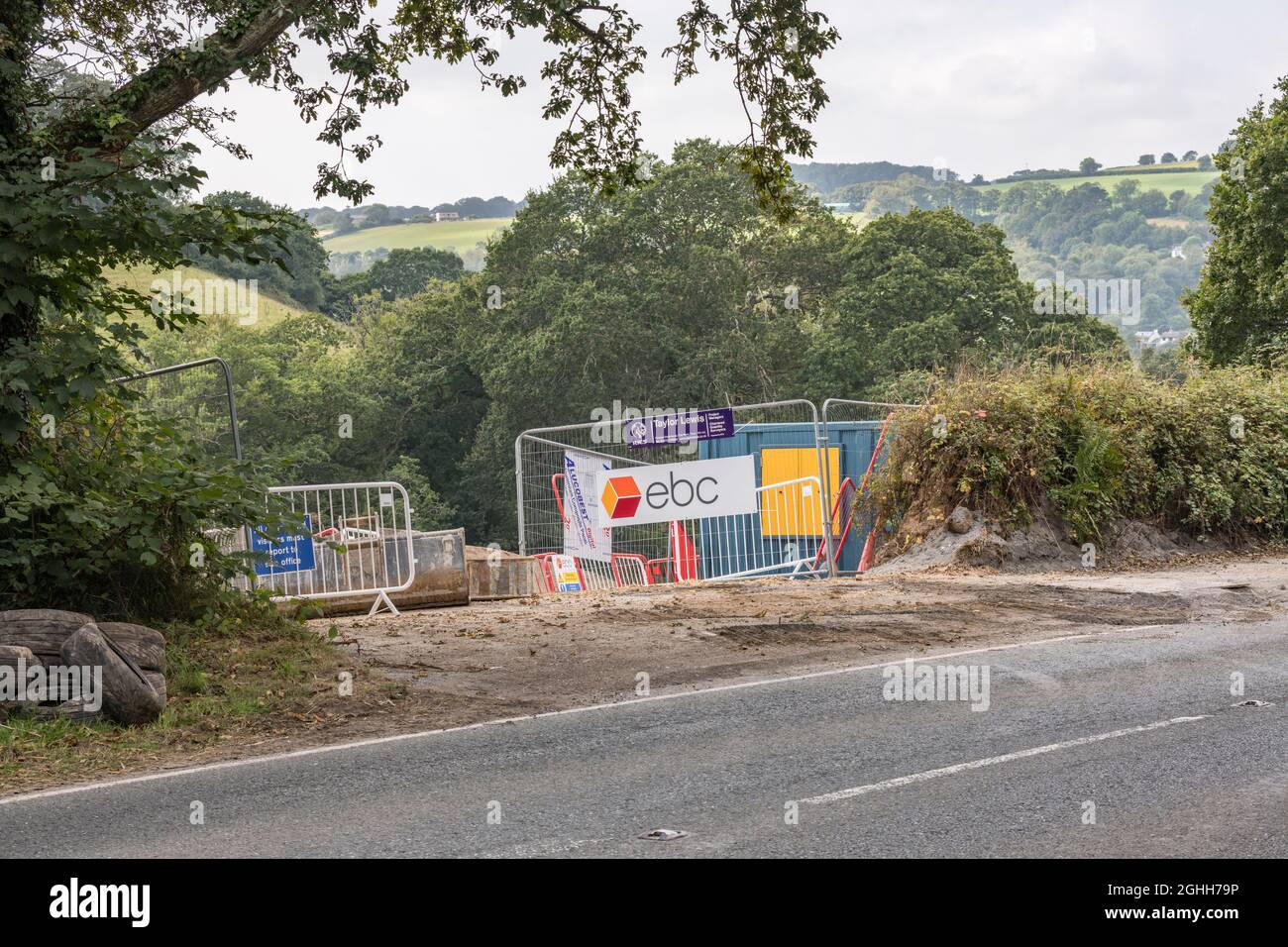 EBC construction site in Lostwithiel, Cornwall. With barrier fencing and health and safety sign requiring drivers & visitors to report to site office. Stock Photo