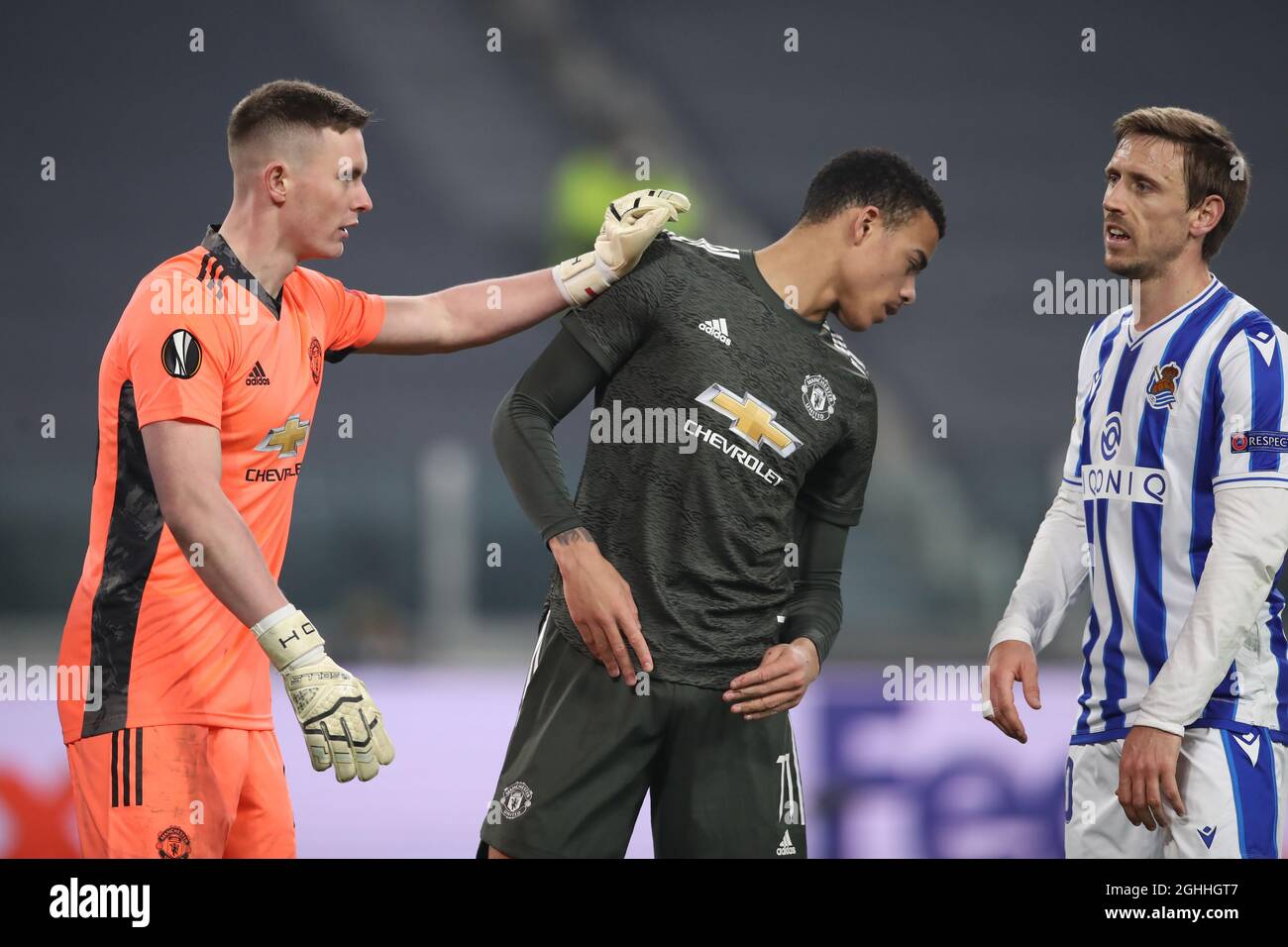 Nacho Monreal of Real Sociedad looks on as Dean Henderson of Manchester United gives a pat on the chest to his team mate Mason Greenwood during the UEFA Europa League match at Juventus Stadium, Turin. Picture date: 18th February 2021. Picture credit should read: Jonathan Moscrop/Sportimage via PA Images Stock Photo