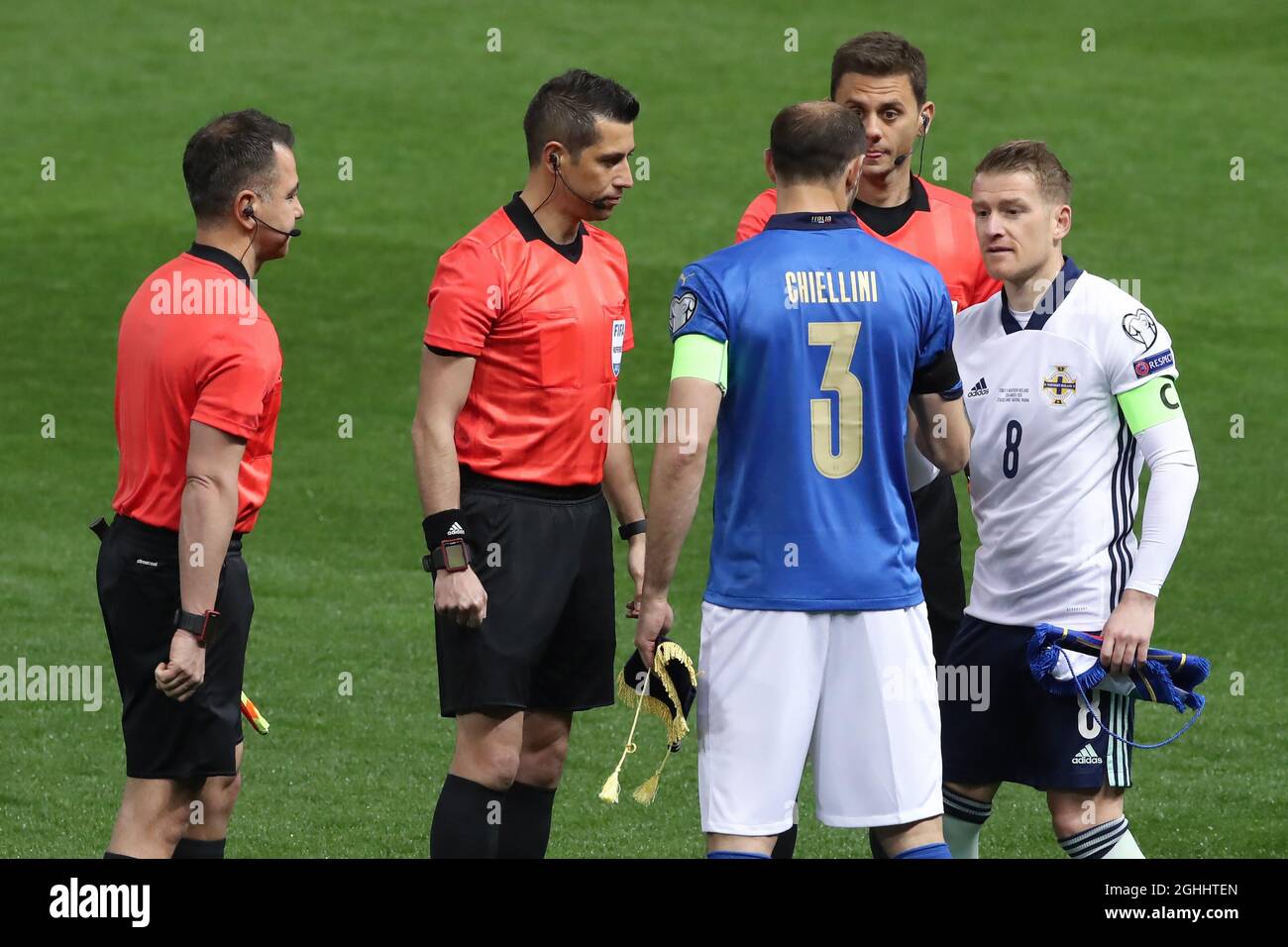 Giorgio Chiellini of Italy shakes hands with Steven Davis of Northern Ireland during the coin toss with the referee Ali Palabiyik and his two assistants Serkan Olguncan and Kerem Ersoy of Turkey prior to kick off in the Fifa World Cup qualifiers match at Stadio Ennio Tardini, Parma. Picture date: 25th March 2021. Picture credit should read: Jonathan Moscrop/Sportimage via PA Images Stock Photo