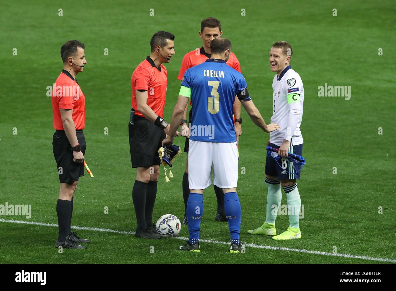 Giorgio Chiellini of Italy jokes with Steven Davis of Northern Ireland during the coin toss with the referee Ali Palabiyik and his two assistants Serkan Olguncan and Kerem Ersoy of Turkey prior to kick off in the Fifa World Cup qualifiers match at Stadio Ennio Tardini, Parma. Picture date: 25th March 2021. Picture credit should read: Jonathan Moscrop/Sportimage via PA Images Stock Photo