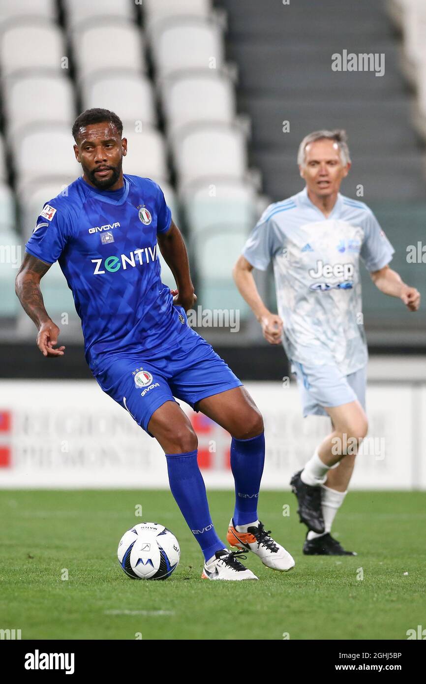 Turin, Italy, 25th May 2021. Former Brazil and FC Internazionale defender Douglas Maicon turns with the ball as Carlos Tavares CEO of Stellantis looks on  during the Charity Match match at Allianz Stadium, Turin. Picture credit should read: Jonathan Moscrop / Sportimage via PA Images Stock Photo
