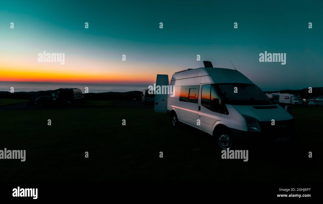 Parked van with a seascape on the background during sunset Stock Photo ...