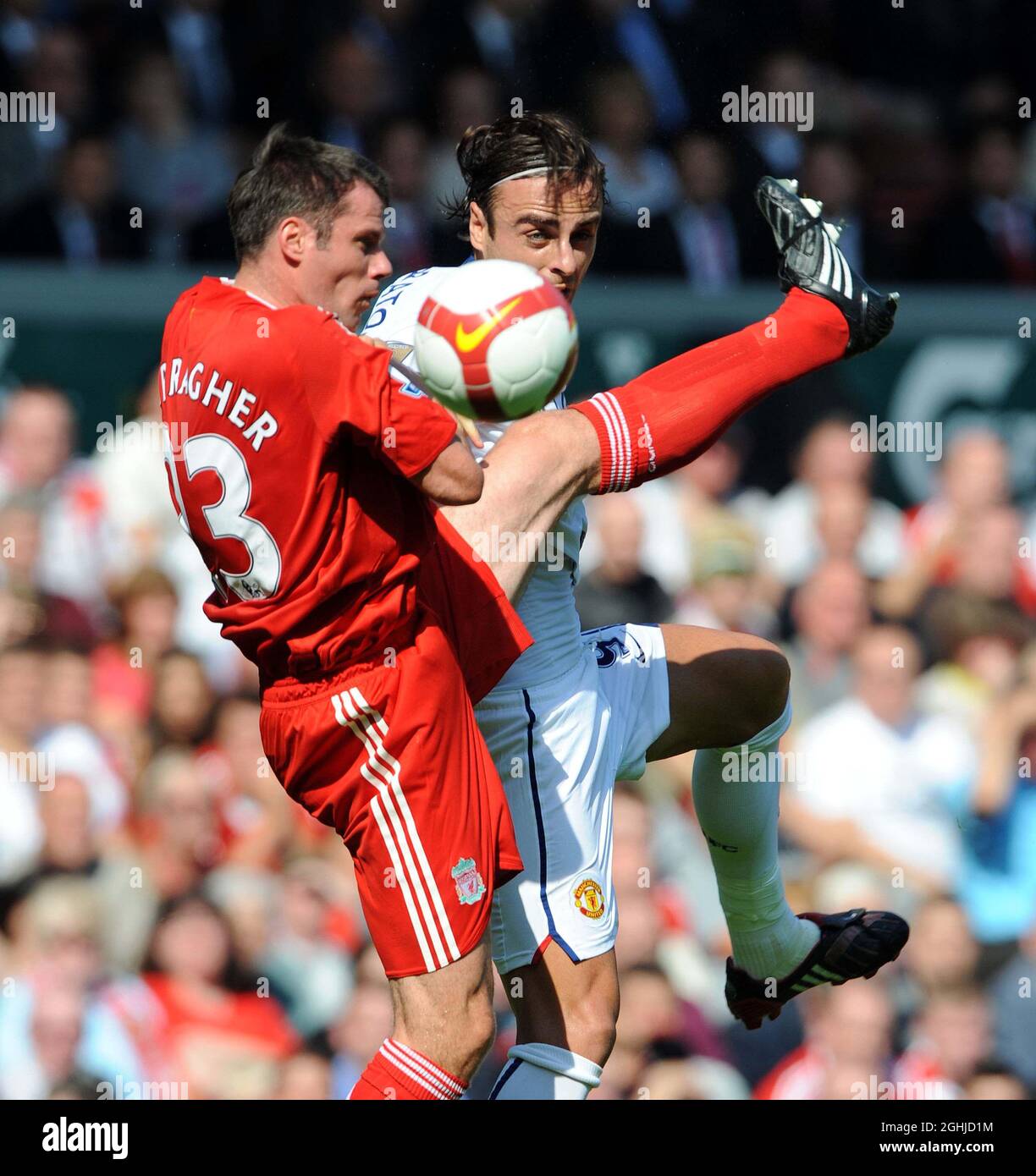 Dimitar Berbatov of Manchester United and Jamie Carragher of Liverpool battles during the (2-1) The Barclays Premier League match in London . Stock Photo