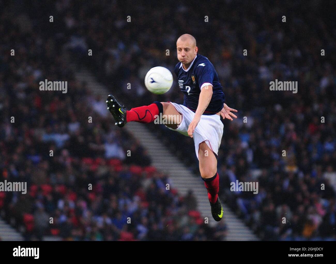 Alan Hutton of Scotland controls the ball mid air during the World Cup European Qualifying match at Hampden Park, Glasgow. Stock Photo