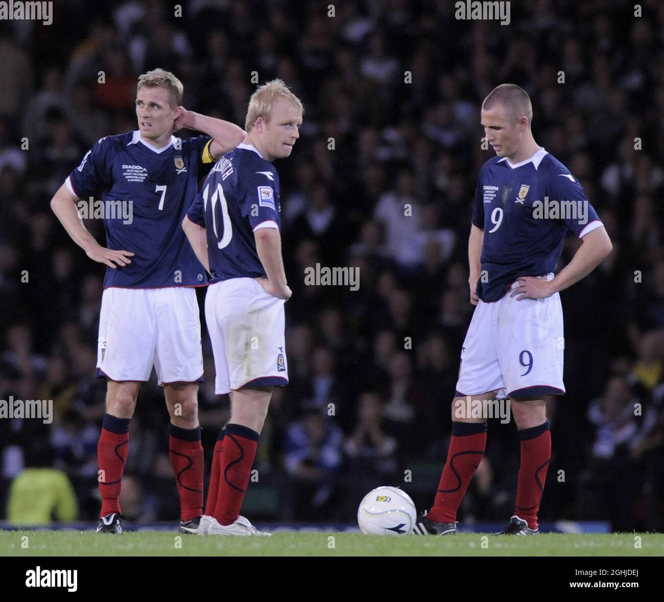 Dejected Scottish players wait for the restart after conceding a goal to Holland during the World Cup European Qualifier match at Hampden Park, Glasgow. Stock Photo