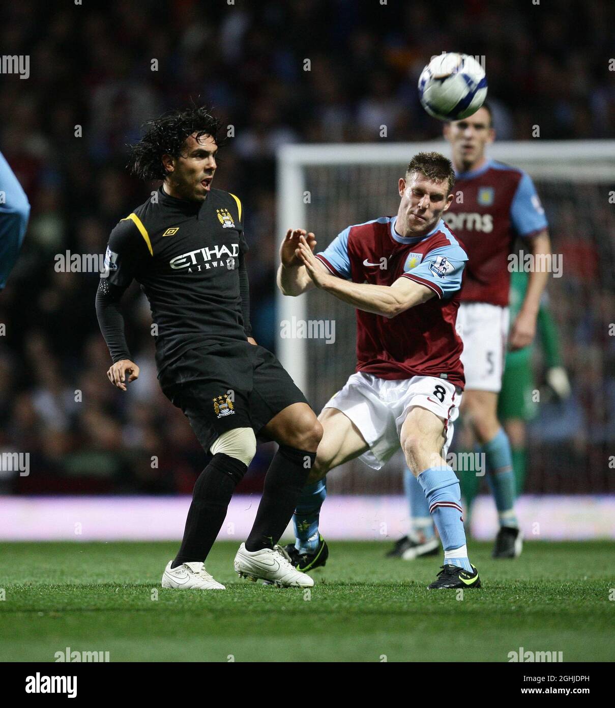 James Milner of Aston Villa (r) competes with Carlos Tevez during the Barclays Premier League match between Aston Villa v Manchester City at Villa Park in Birmingham. Stock Photo