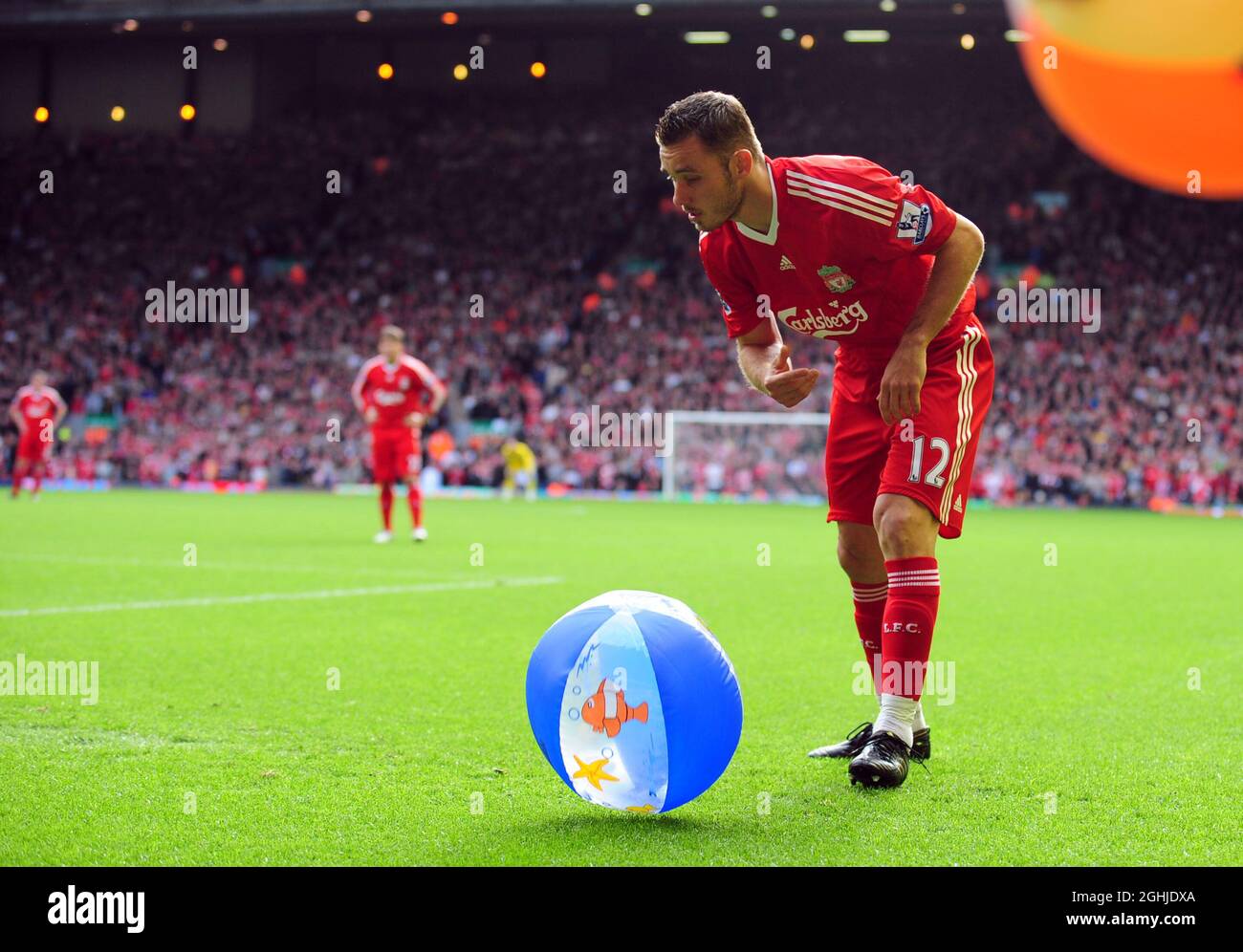 Fabio Aurelio of Liverpool removes a beachball before taking a corner