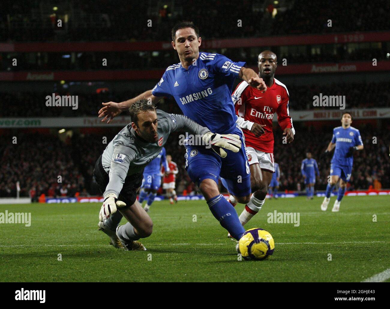Arsenal's Manuel Almunia tussles with Chelsea's Frank Lampard during Barclays Premier League match between Arsenal and Chelsea at Emirates Stadium, London. Stock Photo
