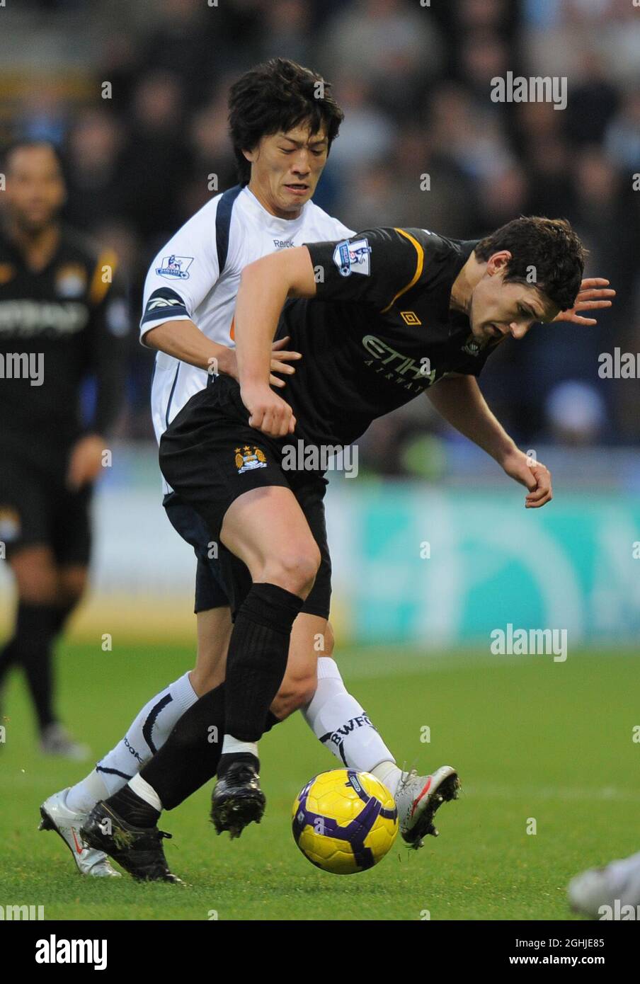 Gareth Barry of Manchester City and Lee Chung Yong of Bolton Wanderers during the Barclays Premier League between Bolton Wanderers and Manchester City at the Reebok Stadium in Horwich. Stock Photo
