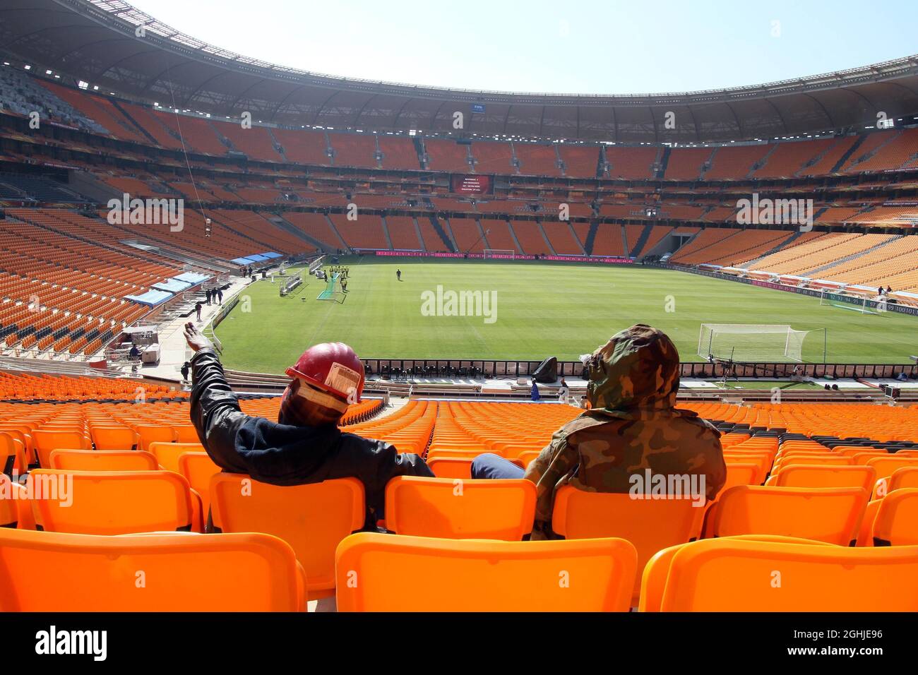 Workmen take a break after putting the finishing touches to the Soccer