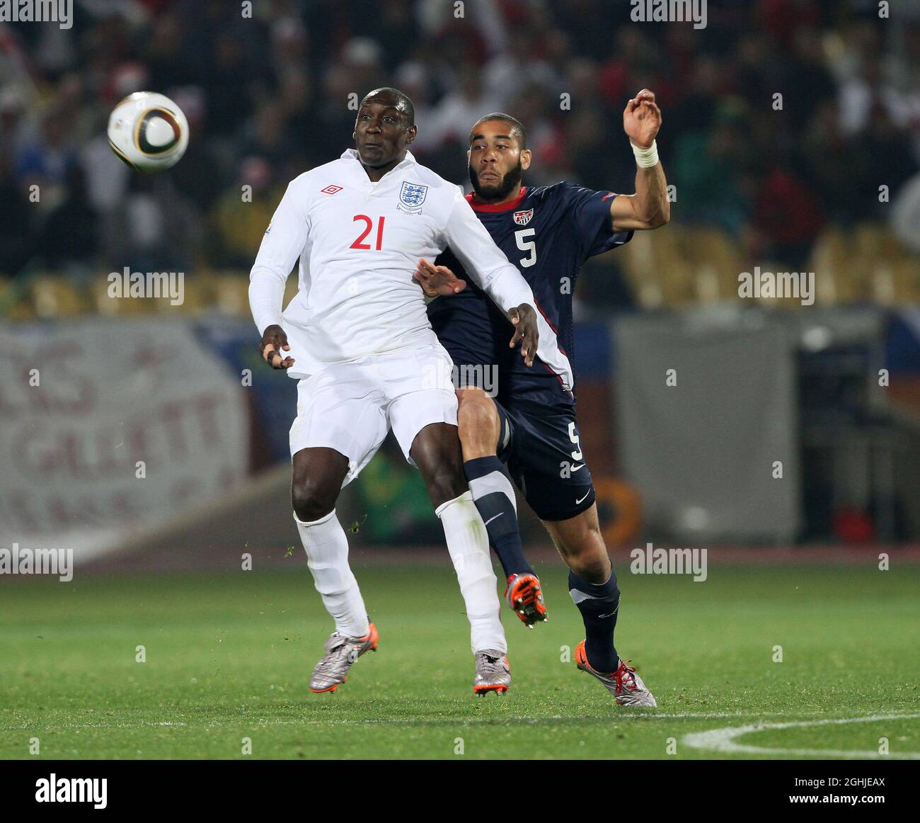 Emile Heskey of England tussles with Oguchi Onyewu of USA during the FIFA World Cup 2010, Group C match between England v USA at Royal Bafokeng Stadium, Rustenburg, South Africa. Stock Photo