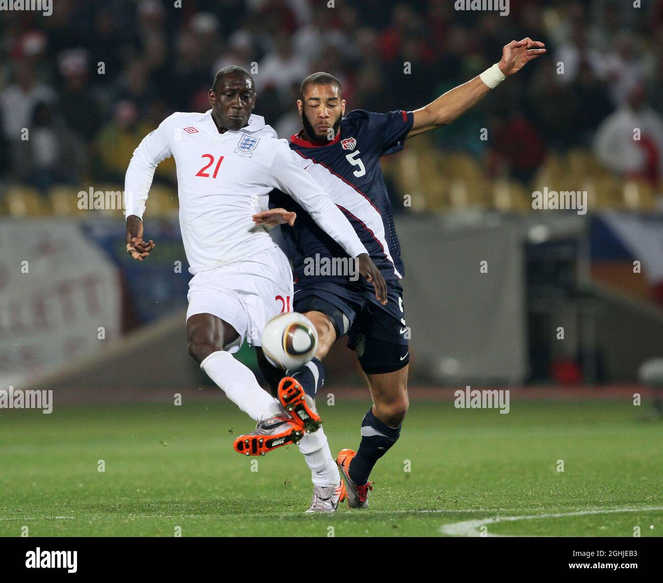 Emile Heskey of England tussles with Oguchi Onyewu of USA during the FIFA World Cup 2010, Group C match between England v USA at Royal Bafokeng Stadium, Rustenburg, South Africa. Stock Photo