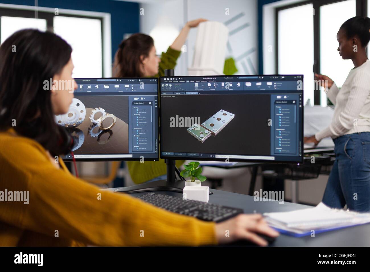 Industrial engineer woman working at pc with two monitors, screens