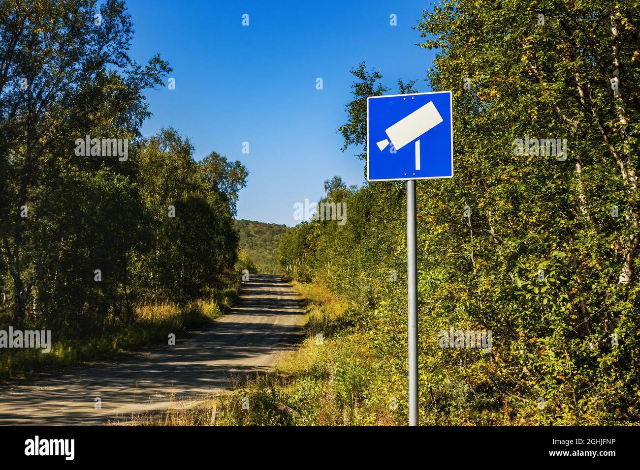 Roadway video surveillance during corona on small mountain forest road between Sweden and Norway - state border closure. Road sign of camera. Stock Photo