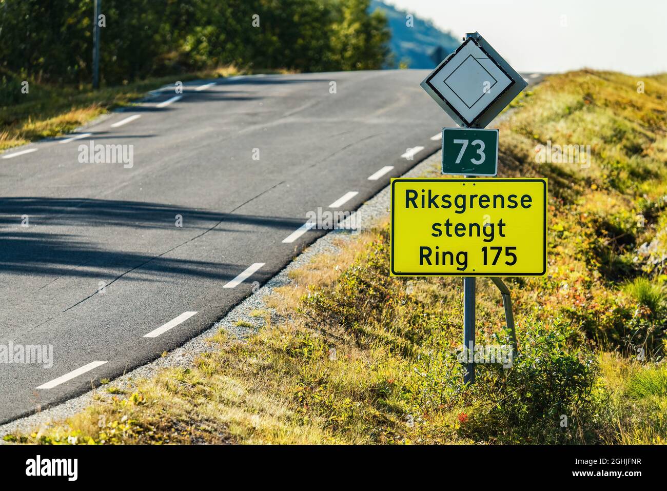 'State border is closed' is written on Norwegian on road sign checkpoint between Sweden and Norway. Corona restrictions stops travel over certain chec Stock Photo